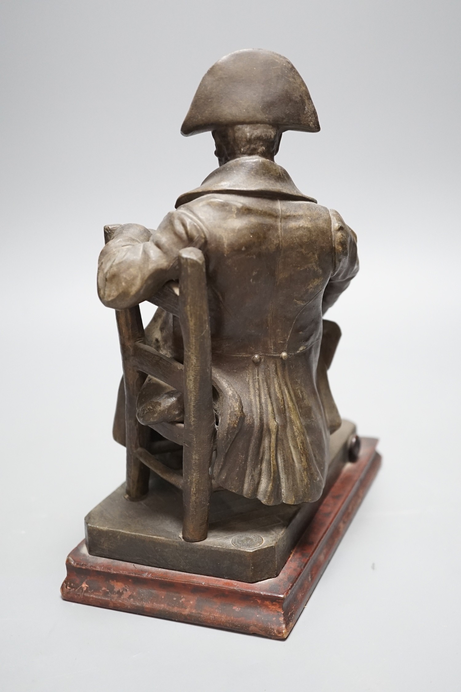 An early 20th century bronzed metal table lamp moulded as Napoleon seated, 26cm